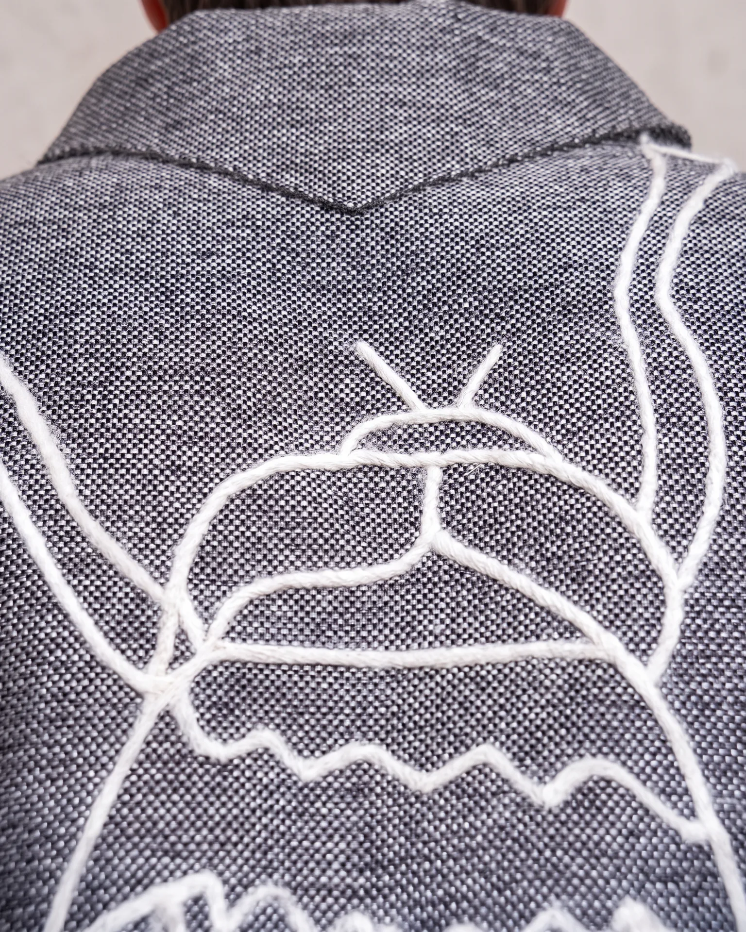 Grey fly jacket back embroidery detail